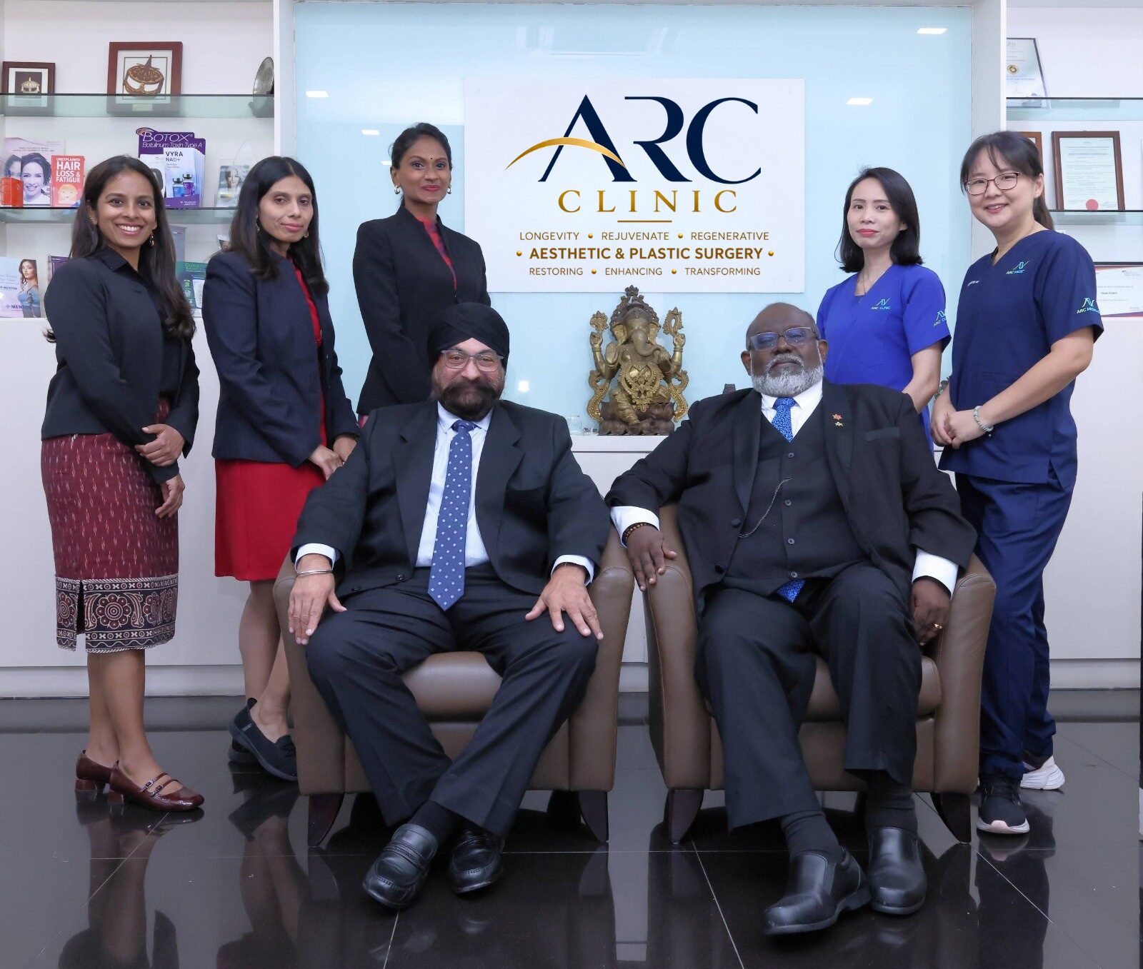 The ARC Clinic team in front of the clinic sign